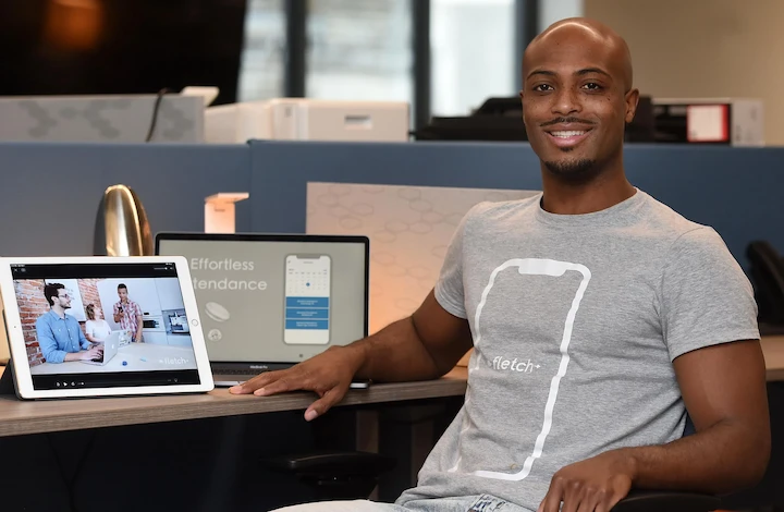 Marquett Davon Burton speaking at a tech event, representing his journey from dropout to multimillionaire entrepreneur.