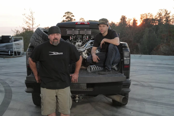 Brad Deberti working in a garage with his father Doug Deberti, assembling parts on a custom truck.